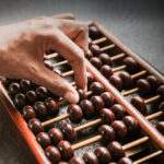 Hand counting with wooden abacus