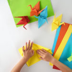 Hands folding origami