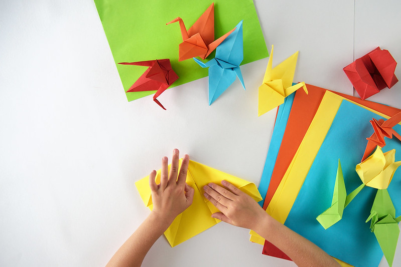 Hands folding origami