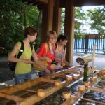 Students purify themselves before visiting the shrine