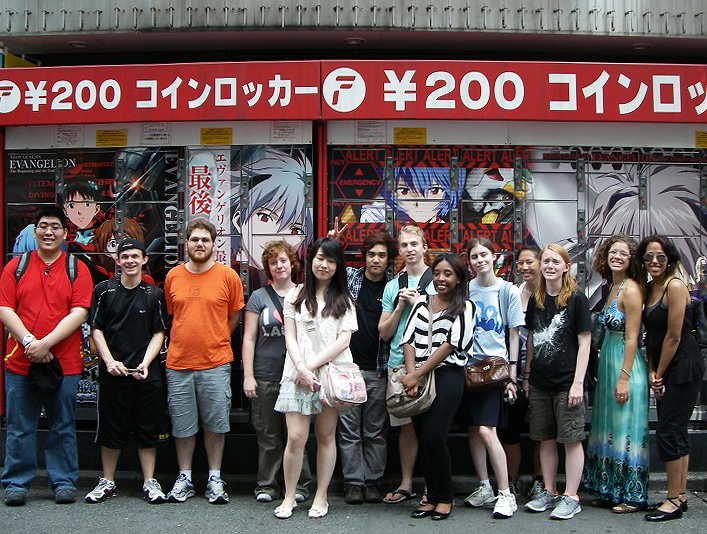 KCP students were all smiles as they posed in the middle of Akihabara. Behind them are coin lockers, fully painted with anime characters.