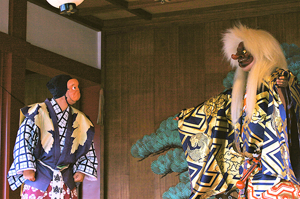 Noh actors with masks.