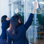 High school students cleaning the classroom