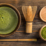Green tea matcha in a bowl on wooden surface