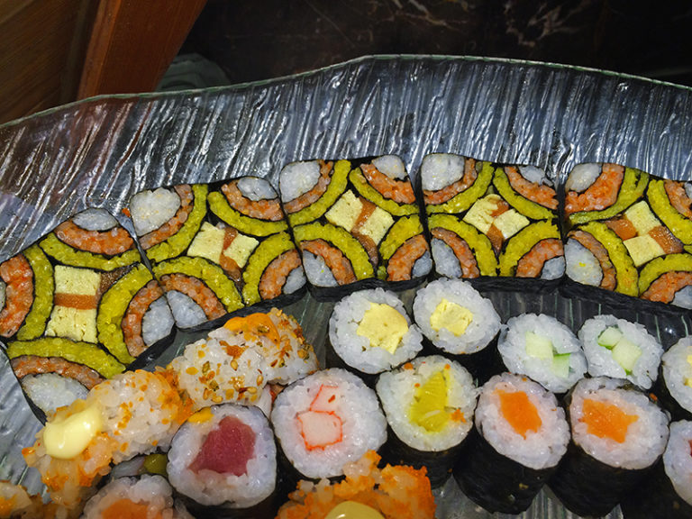 Mosaic sushi (top row) with assorted sushi.