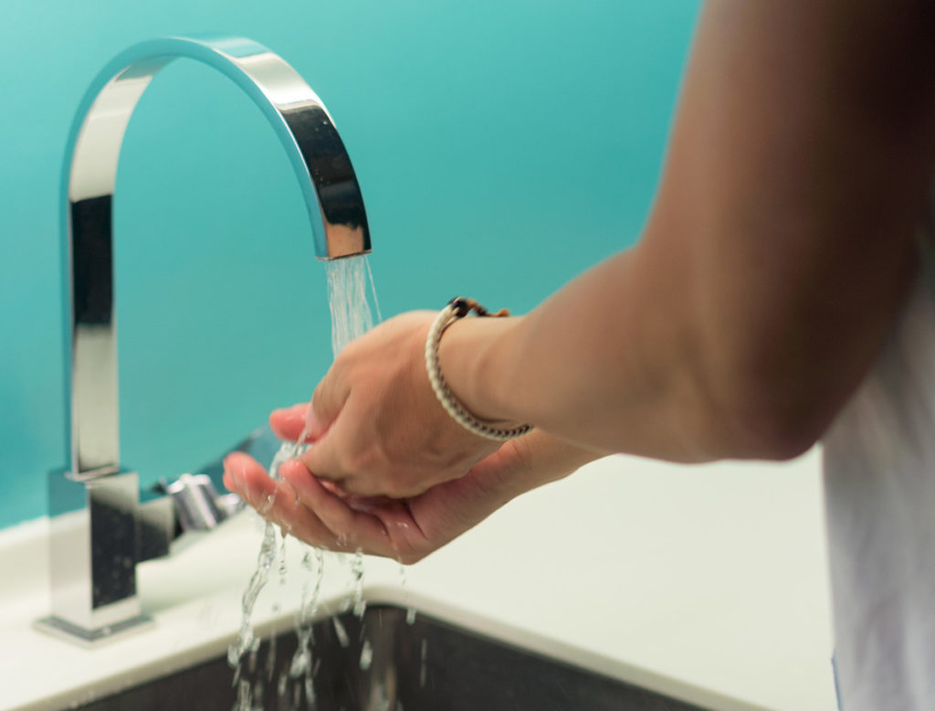 Person washing hands.