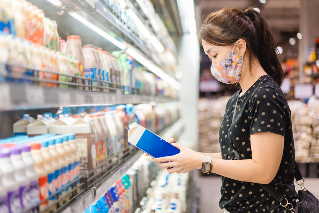 lady shopping for milk at a Japanese grocery store