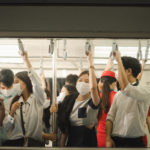 People in train with face masks