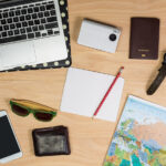 top view of travel items on wooden table