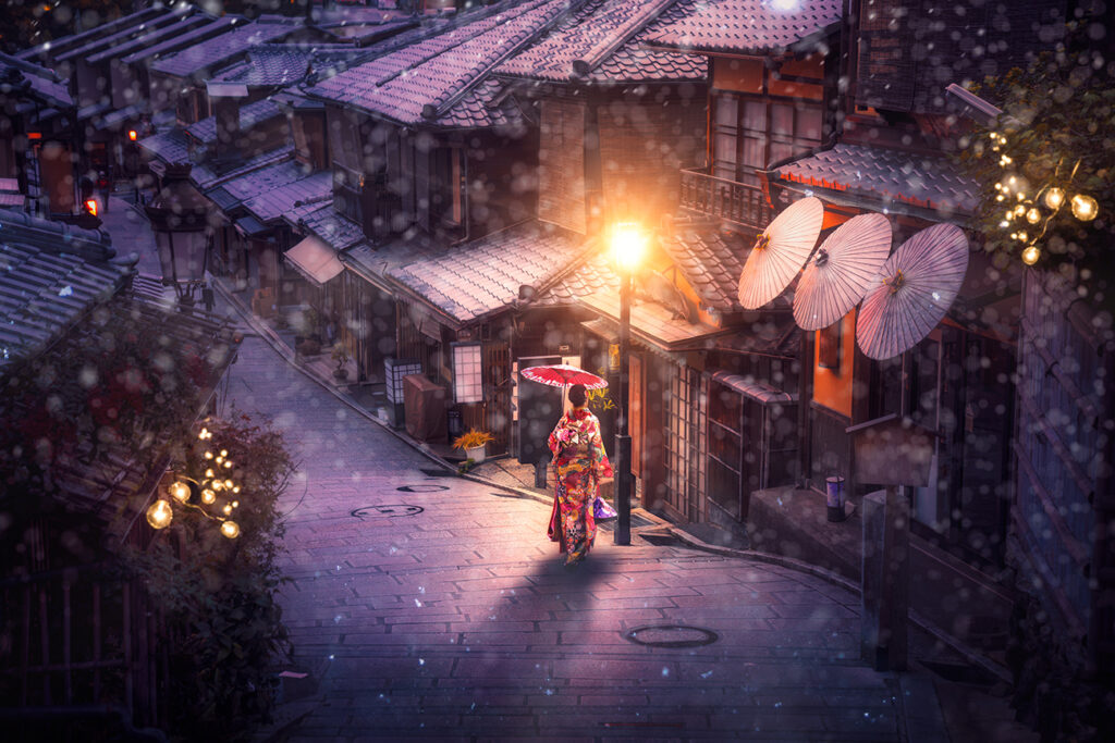 Japanese girl walk with traditional kimono dress in winter season and use an umbrella for protect a snow in Kyoto city, Japan