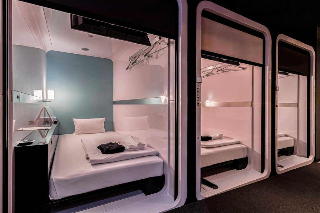 One-story bedroom area is combined inside a modern capsule hotel in Japan