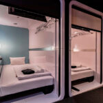 One-story bedroom area is combined inside a modern capsule hotel in Japan