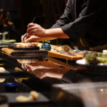 Japanese Chef making uni nigiri omakase style eating. Omakase style Japanese traditional.