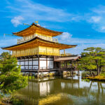 Kinkakuji Temple by the middle of the pond surrounded with Japanese garden