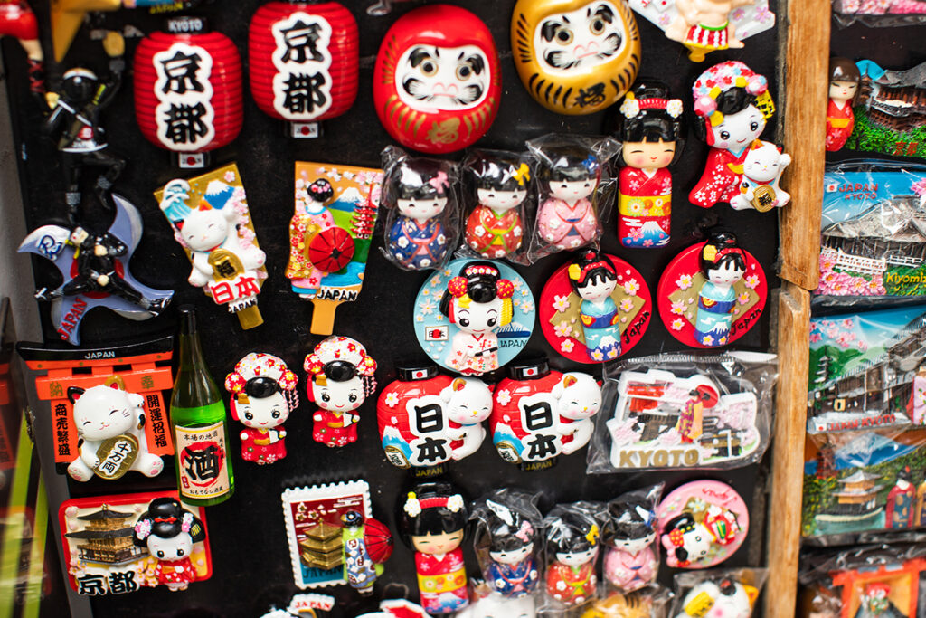Kyoto, Japan - June 26, 2019: Japanese magnets with Kyoto, kokeshi dolls, lantern, fans and other at market in Gion area of Kyoto, Japan