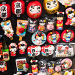 Kyoto, Japan - June 26, 2019: Japanese magnets with Kyoto, kokeshi dolls, lantern, fans and other at market in Gion area of Kyoto, Japan