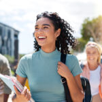 Young woman headed off to school with other students inthe back
