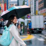 woman holding umbrella during rainy day in Japan