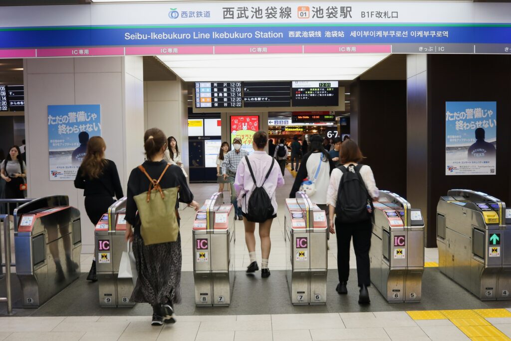 people passing through transit gates in Japan
